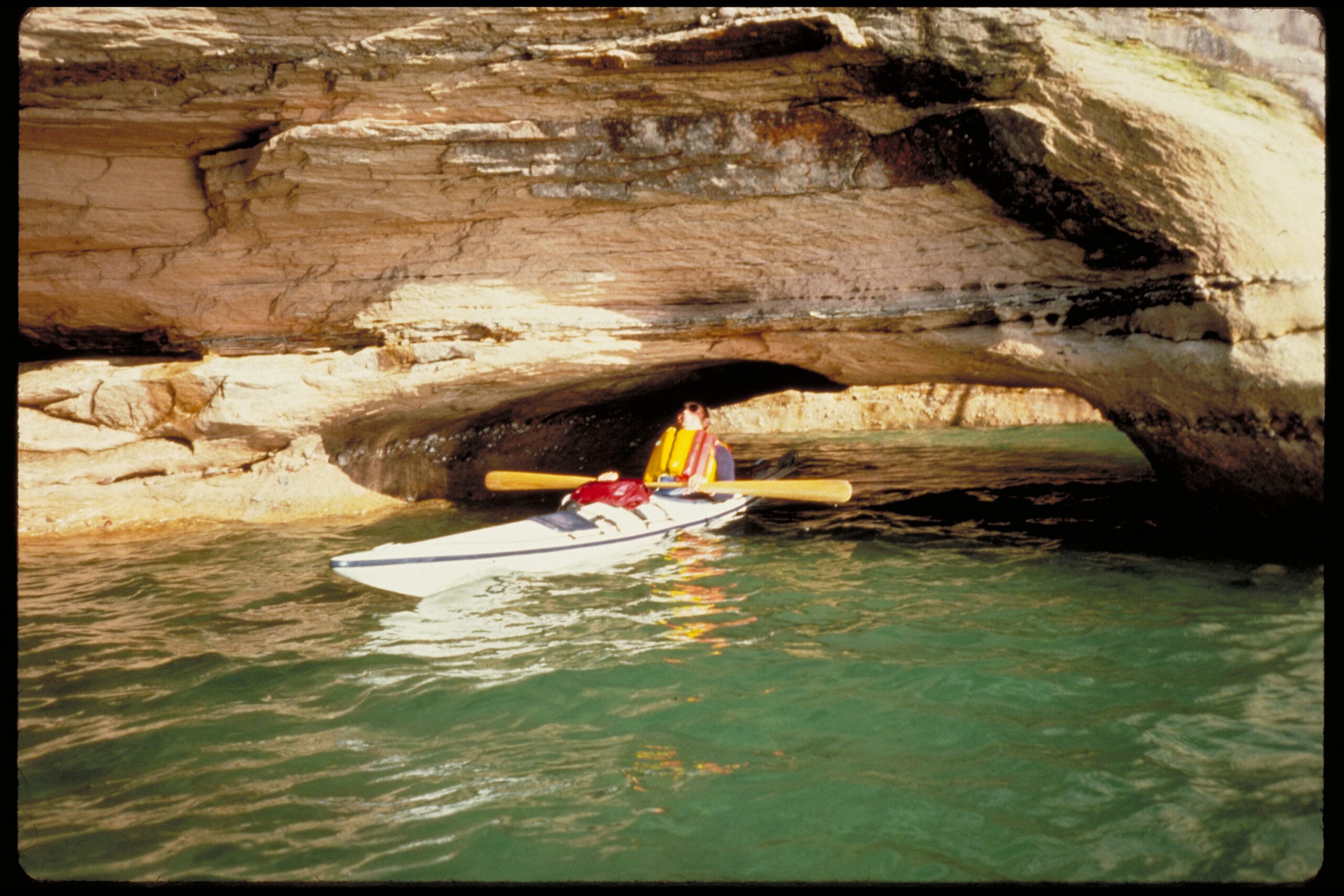 A person is kayaking through a cave.