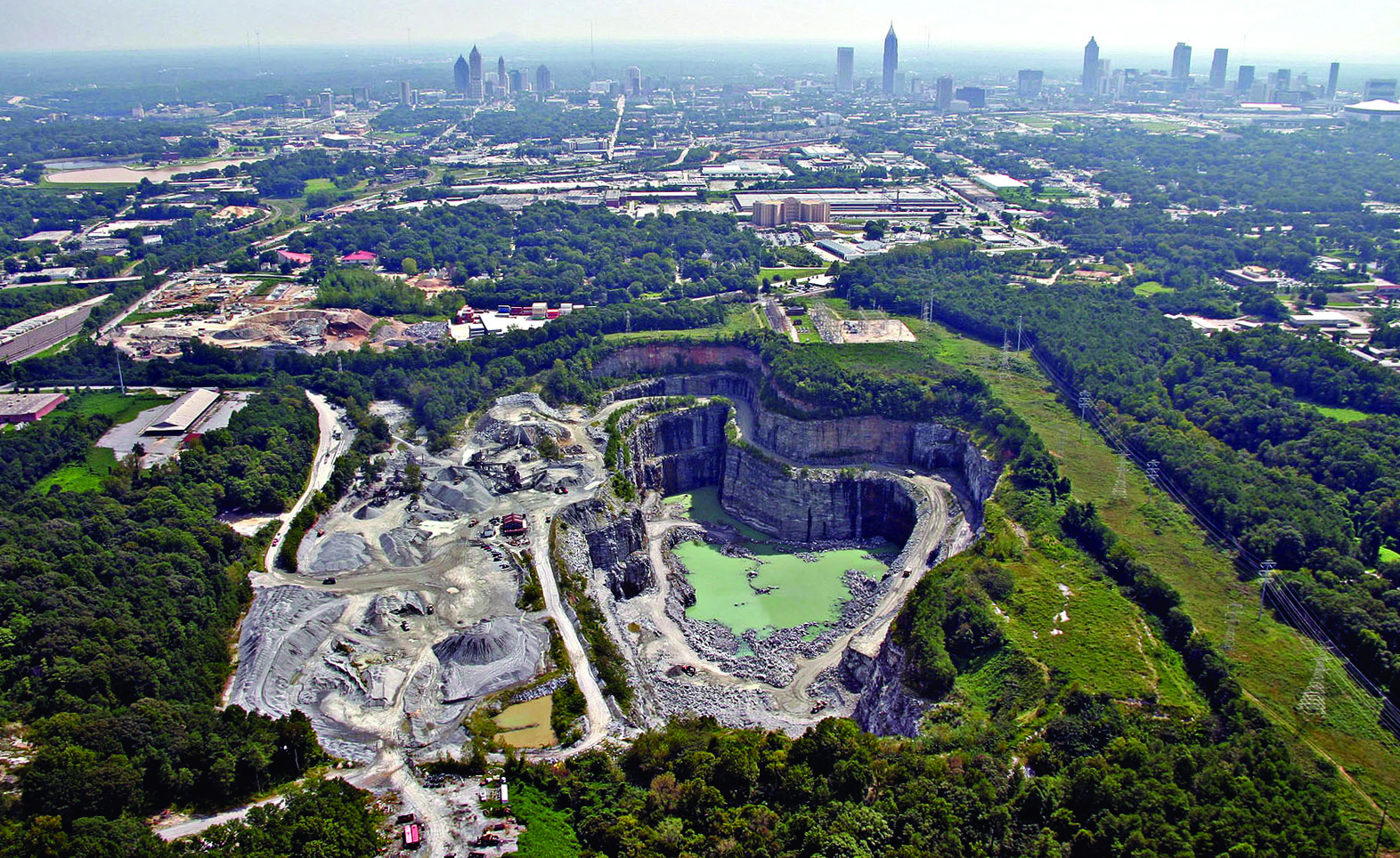 An aerial view of a quarry near a city.