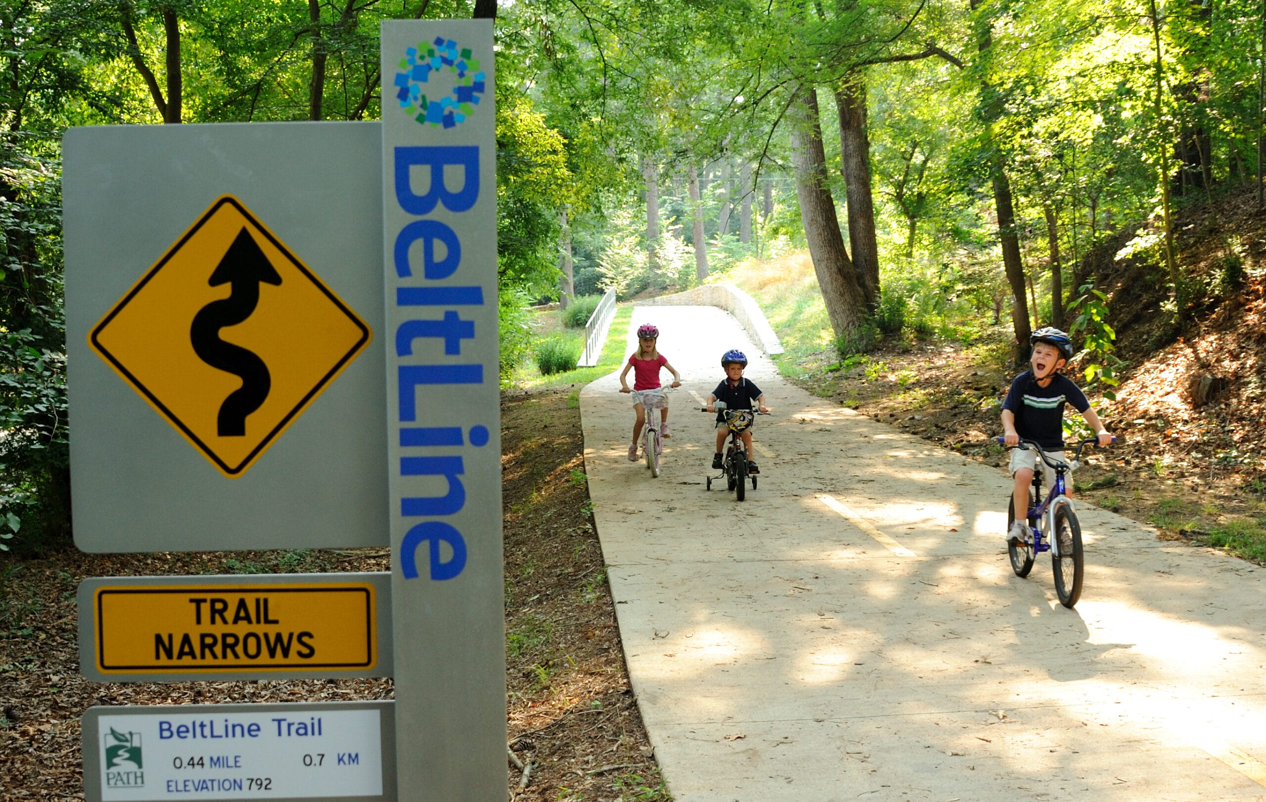 A group of people riding bikes on a trail.