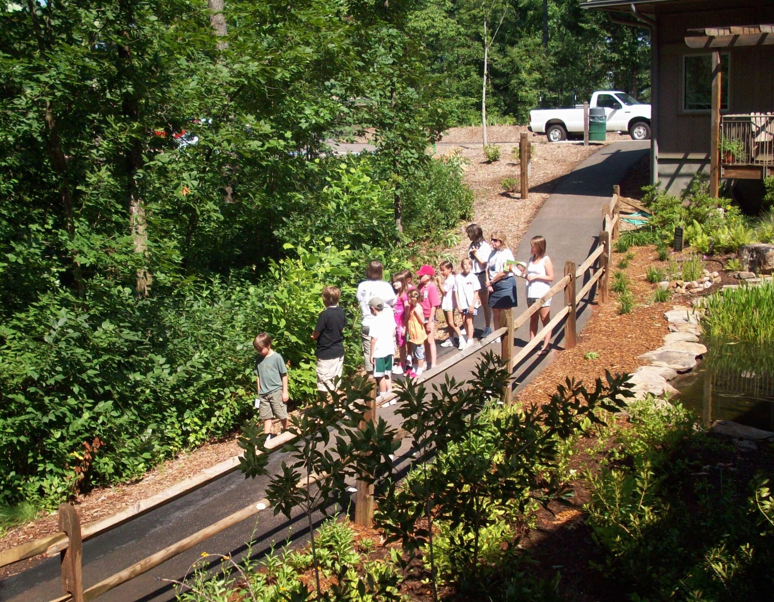A group of people walking down a path.
