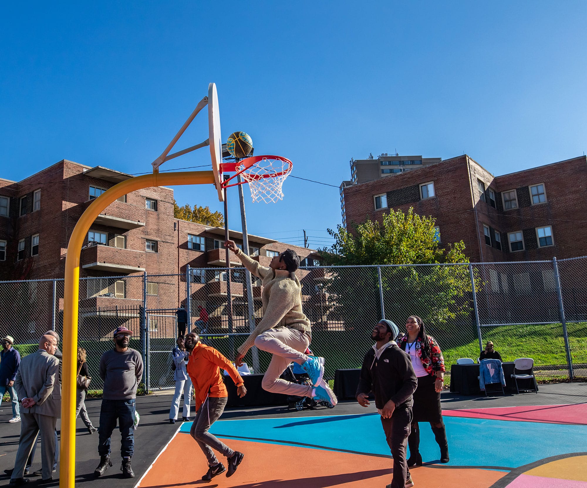 A group of people playing a game of basketball.