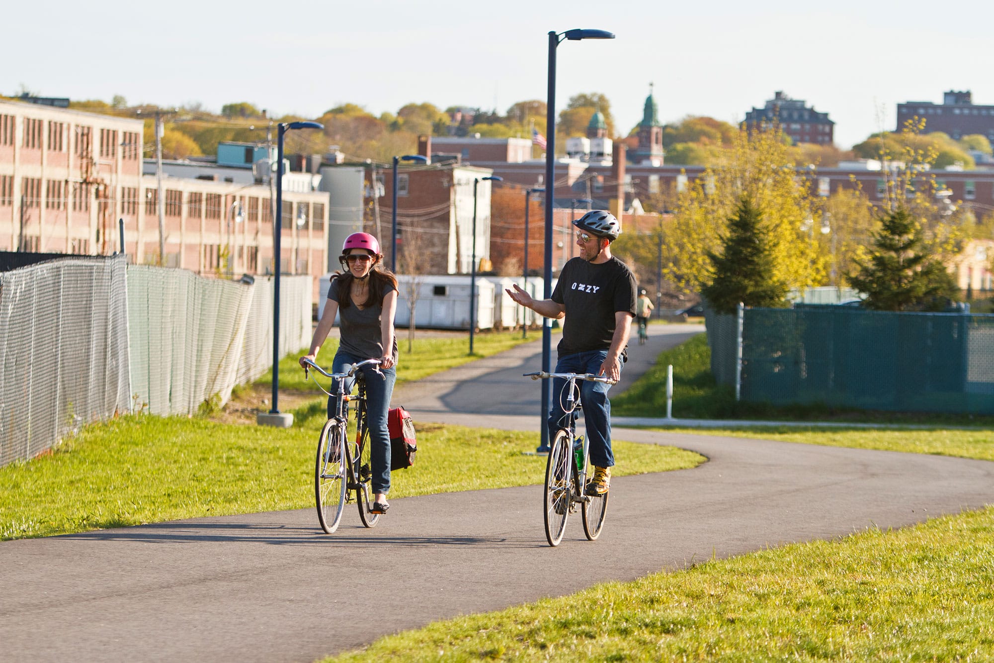 A man and woman riding bicycles on a path.