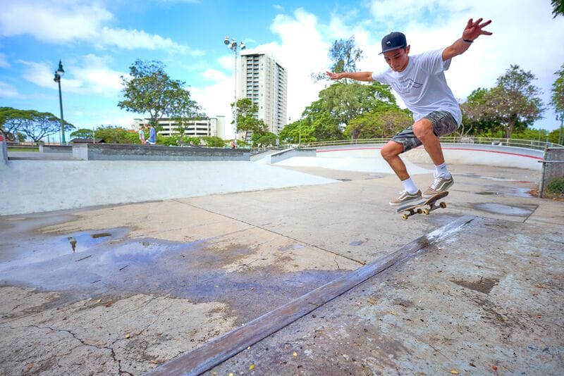 A skateboarder doing a trick in a skate park.