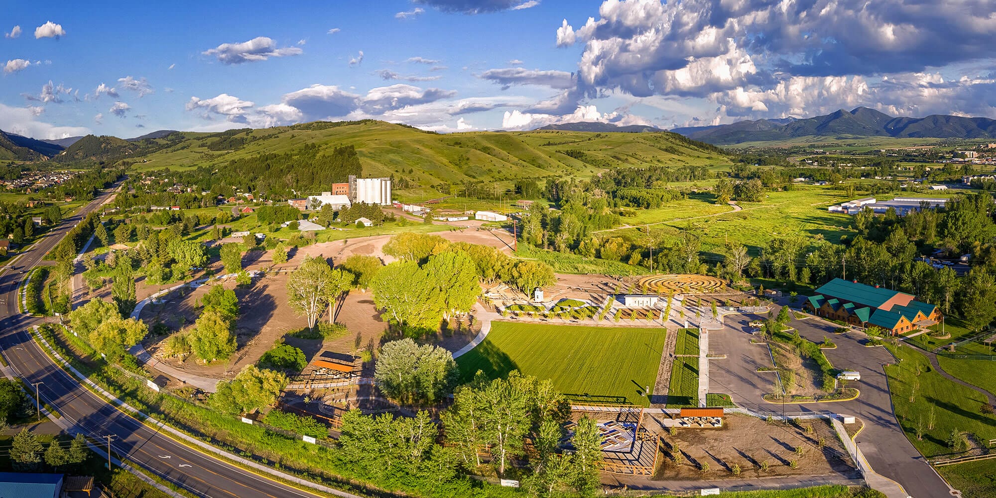 An aerial view of a park with mountains in the background.