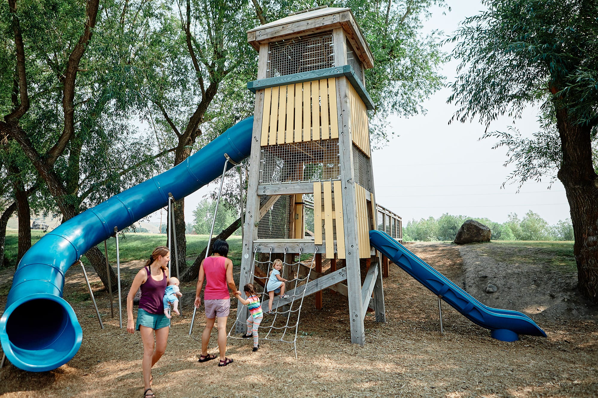 A children's playground with a slide and swings.