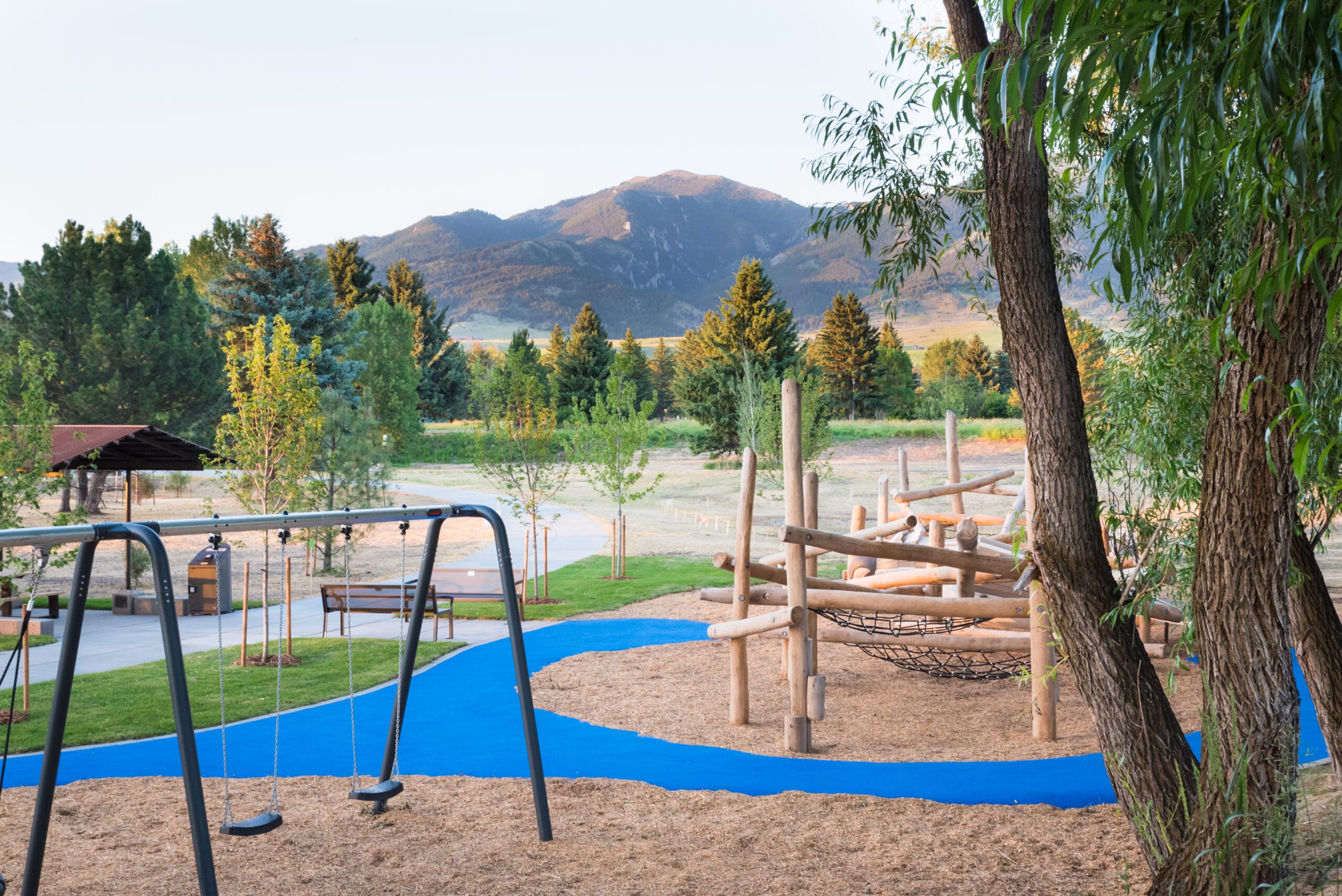 A playground with a swing set and a sand pit.