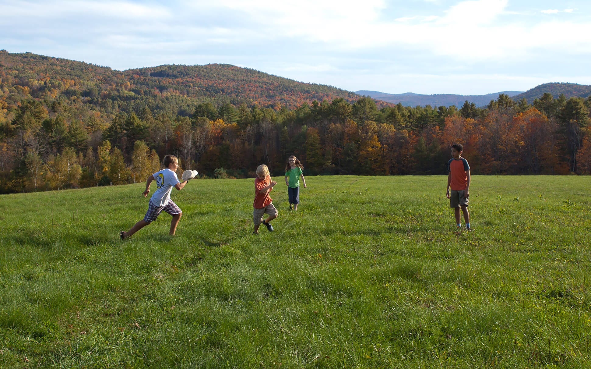 A group of people playing frisbee in a field.