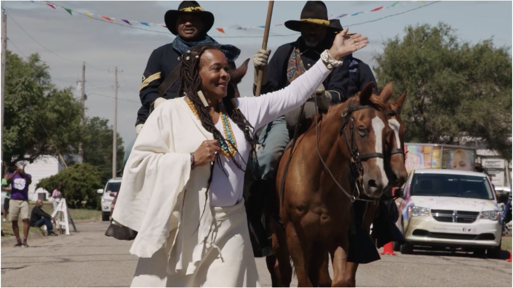 A woman riding a horse in a parade.