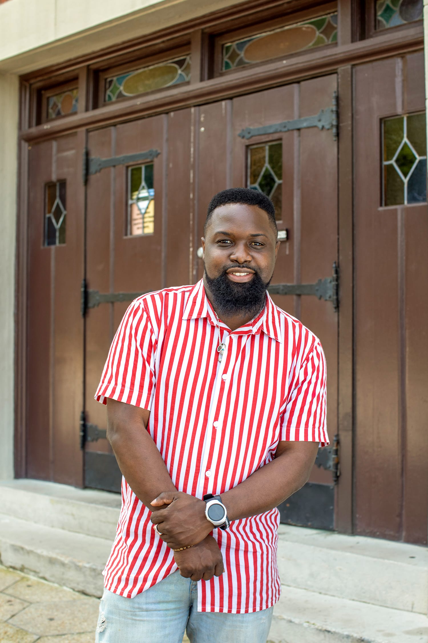 A man wearing a red and white striped shirt.