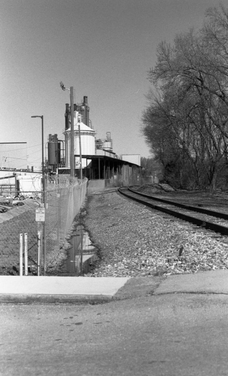 A black and white photo of a railroad track.