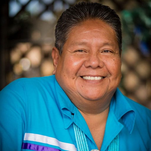 Dr. Ken Lucero, the new director of TPL's Tribal and Indigenous Lands program, smiles while wearing a blue shirt.