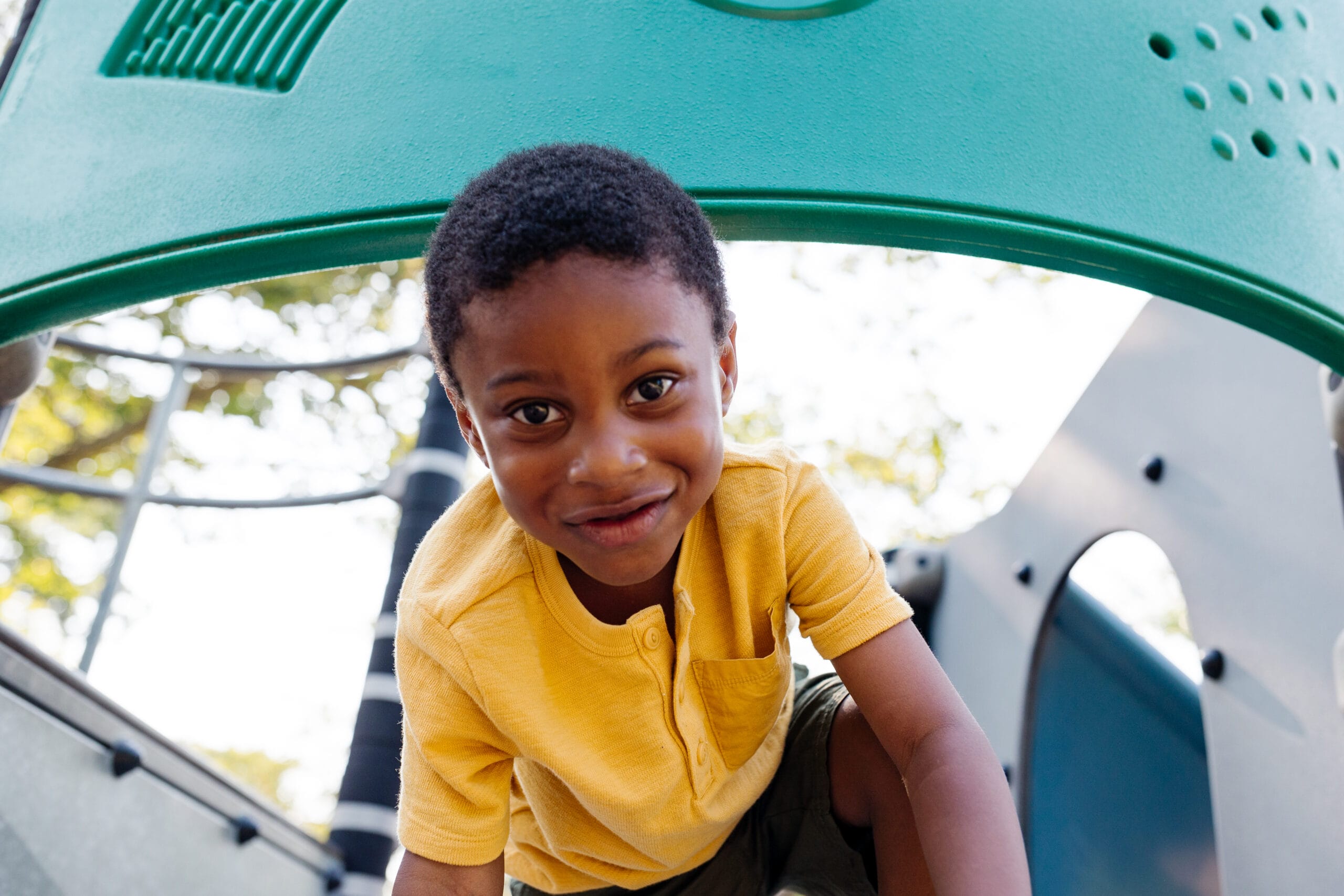 A young boy playing on a playground.