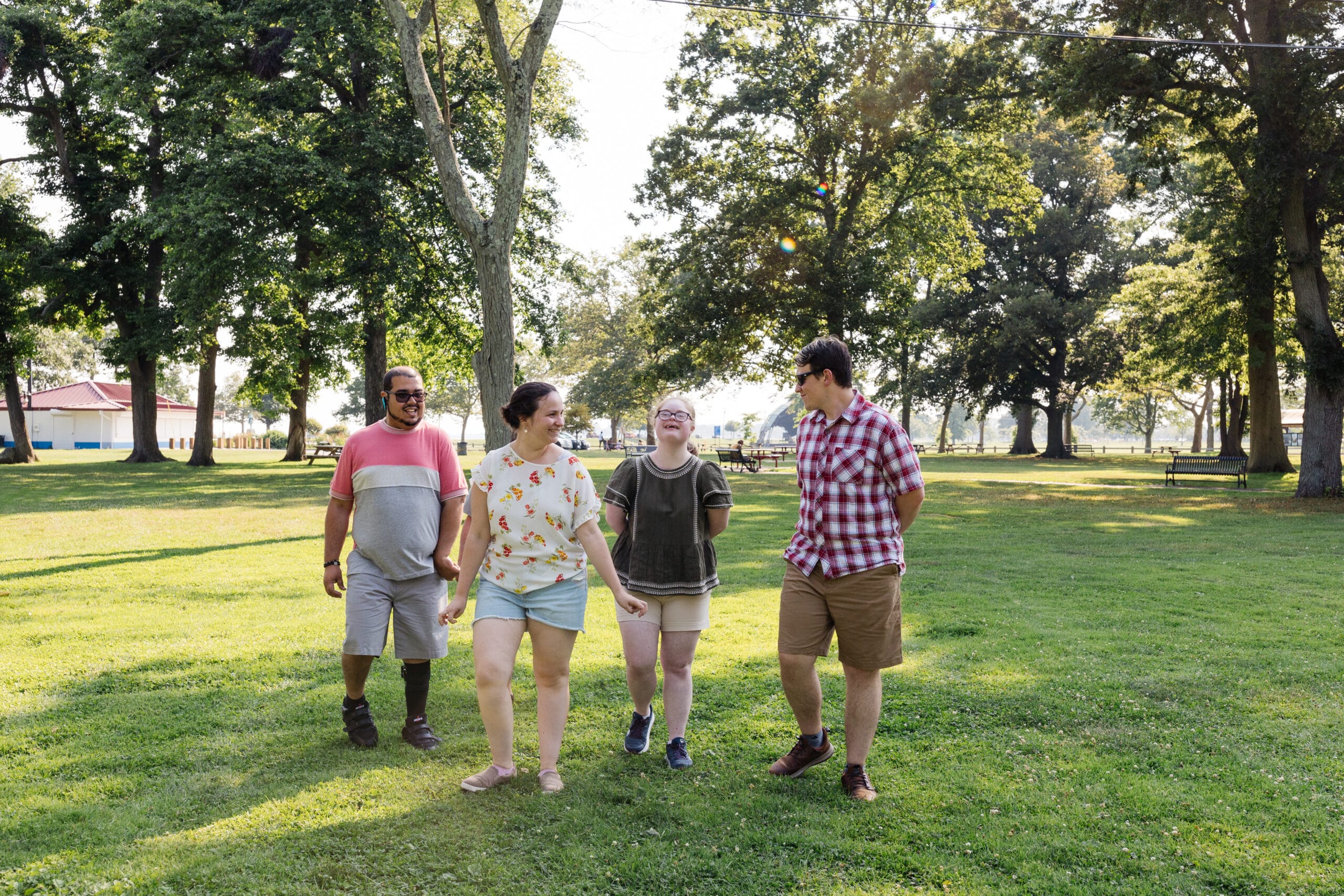 A group of people walking in a park.